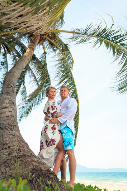 istock Happy young couple hugging on the beach 824203932