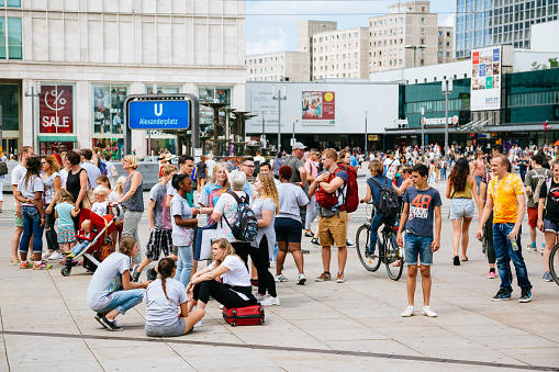 local people and tourists walking at Alexanderplatz. Alexanderplatz is a central square and traffic junction in Berlin's Mitte district. One of city's the most visited squares.
