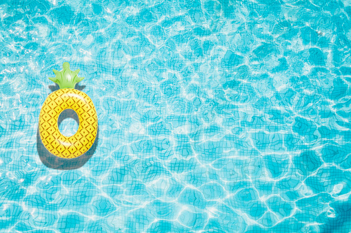 Pineapple pool float, ring floating in a refreshing blue swimming pool