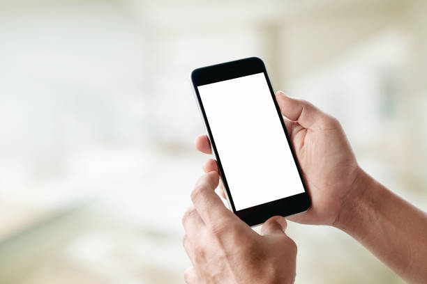 Mock up Smartphone : Man hands holding mobile phone with abstract bokeh background.