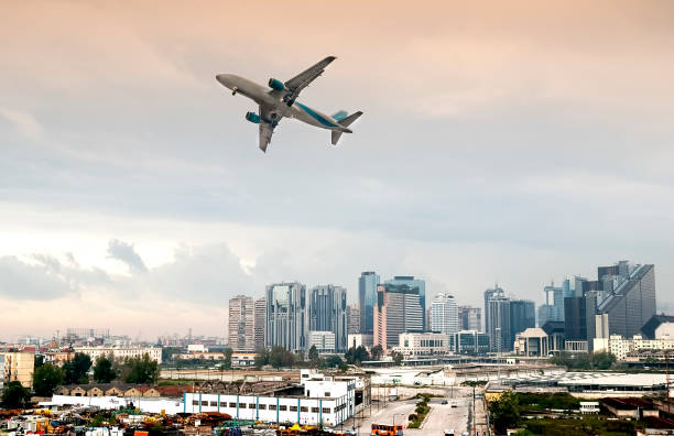 istock Airplane Flying over buildings 824211902
