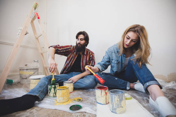 istock Young couple decorating apartment 824212094