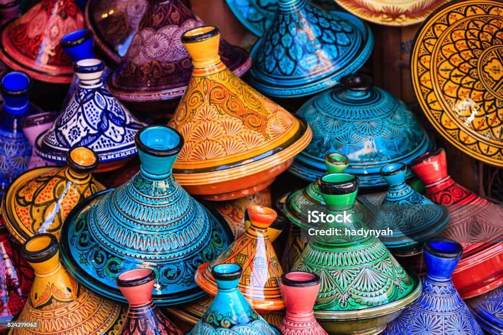 Maroccan tajine pots at a souk in Marrakech Colorful Moroccan cooking pots at a souk in Marrakech. A tajine is a Maroccan dish from that is named after the special earthenware pot in which it is cooked. Morocco Stock Photo