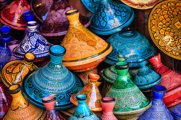 Maroccan tajine pots at a souk in Marrakech Colorful Moroccan cooking pots at a souk in Marrakech. A tajine is a Maroccan dish from that is named after the special earthenware pot in which it is cooked. tajine stock pictures, royalty-free photos & images