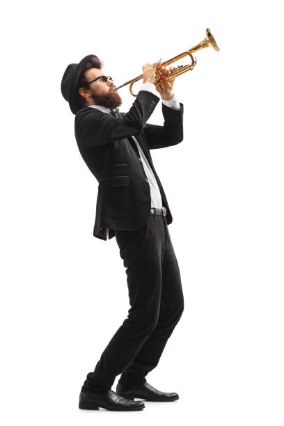 Musician playing a trumpet Full length profile shot of a musician playing a trumpet isolated on white background full body isolated stock pictures, royalty-free photos & images