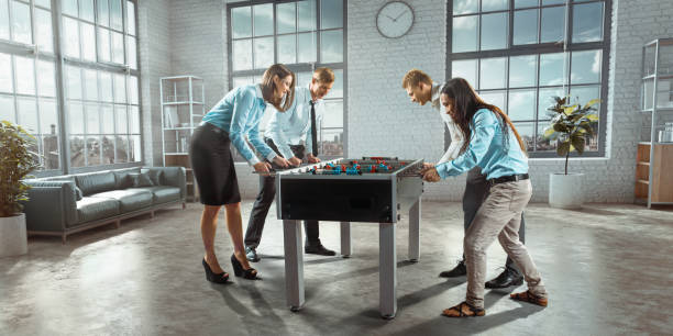 istock Colleagues in the office play table football/kicker game 824227782