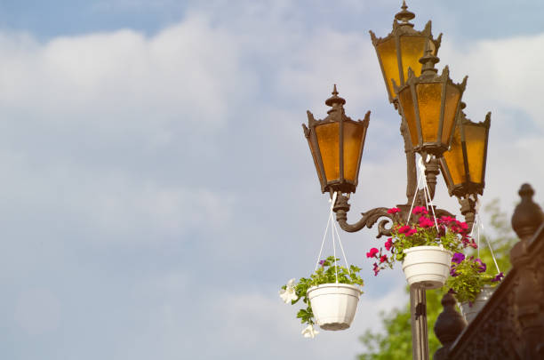 Three orange street lights on the sky background