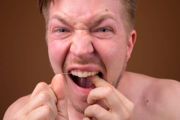 istock Studio shot of young handsome man shirtless while grooming against colored background 824238418