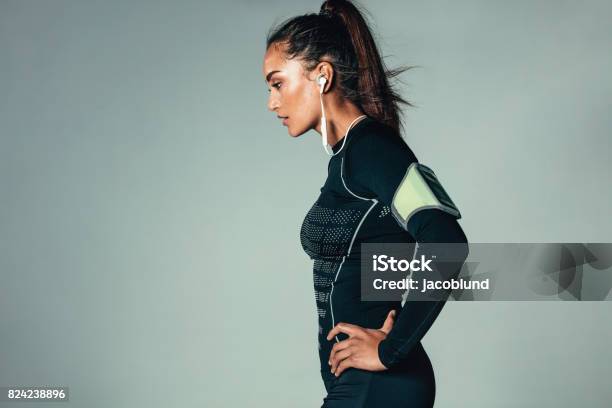 Fit Young Woman Standing With Hands On Hips Stock Photo - Download Image Now - Exercising, Women, Athlete