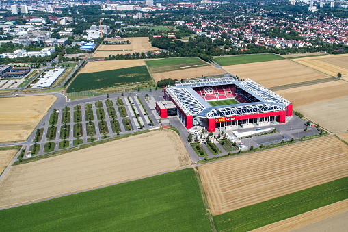 Mainz, Germany - July 26, 2017: Aerial view of Opel Arena - Mainz, Germany. Opel Arena (or 1. FSV Mainz 05 Arena) is a large multi-purpose stadium in Mainz, Rhineland-Palatinate, Germany. it was opened in 2011 and has a capacity of 34,034 people. It is home of the German Bundesligaclub 1. FSV Mainz 05.  In the background the city of Mainz
