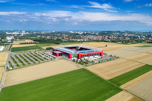 Mainz, Germany - July 26, 2017: Aerial view of Opel Arena - Mainz, Germany. Opel Arena (or 1. FSV Mainz 05 Arena) is a large multi-purpose stadium in Mainz, Rhineland-Palatinate, Germany. it was opened in 2011 and has a capacity of 34,034 people. It is home of the German Bundesligaclub 1. FSV Mainz 05.  In the background the city of Mainz