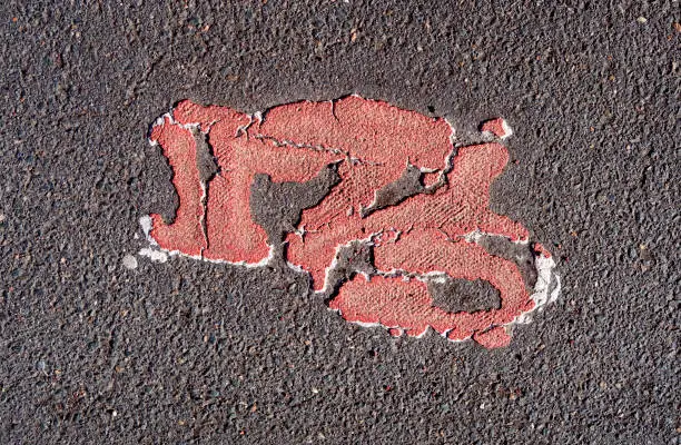 Worn cycle path marking on a dry inner-city asphalt road