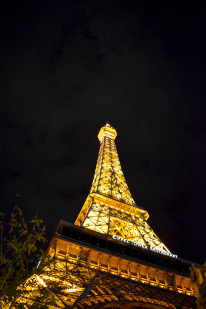 LAS VEGAS, NV, USA - December 25, 2016: Replica Eiffel Tower which forms part of the Paris hotel along the Las Vegas strip during the night time. Las Vegas is located in the Mojave Desert in Nevada. It is famous for it's themed hotels, gambling, and high end lifestyle.
