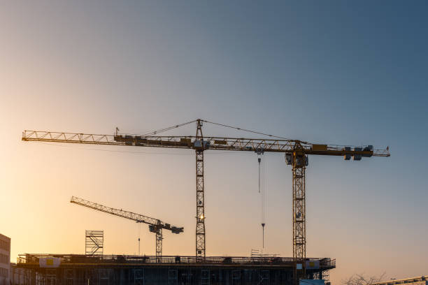 istock Industrial construction cranes and building silhouettes 824246762