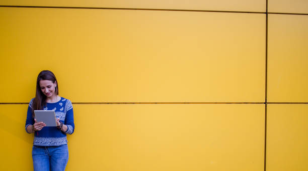 istock Woman by the yellow wall 824246812