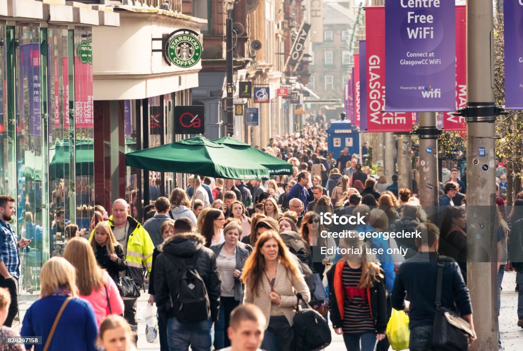 Crowds on Buchanan Street in central Glasgow, Scotland Glasgow, Scotland, UK - Crowds of people passing shops and businesses on Buchanan Street, one of Glasgow's busiest shopping streets. Customer Stock Photo