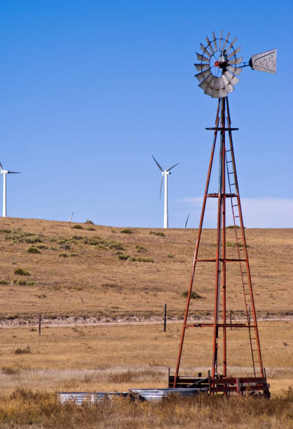 istock Vintage windmill and modern wind turbines 824247572