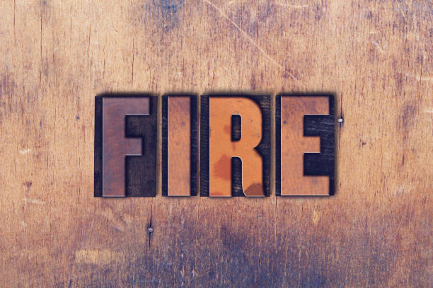 istock Fire Theme Letterpress Word on Wood Background 824247784