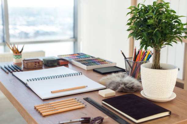 Side view of a painter workspace. Wooden desk with artistic tools prepared for pastel drawing