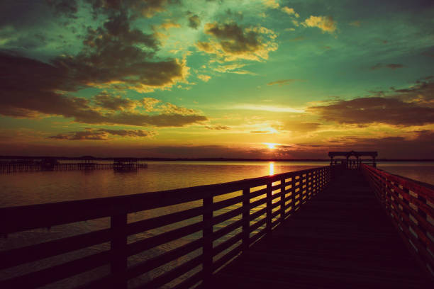 istock Pier over lake with majestic sunset cloudscape 824250976
