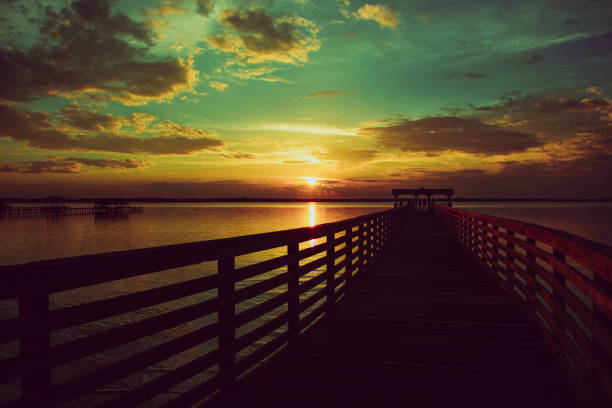 istock Pier over lake with majestic sunset cloudscape 824250980