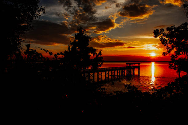 istock Pier over lake with majestic sunset cloudscape 824250990