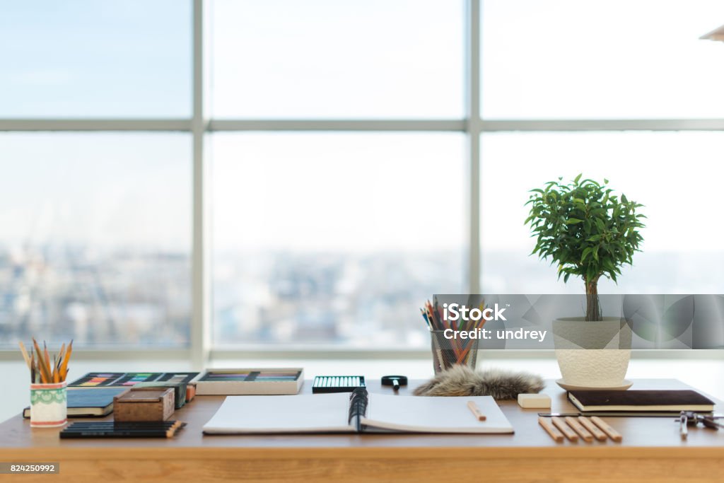 Artist workplace ready for pastel, drawing. Colorful pencils and crayons palette organized on the desktop Artist workplace ready for pastel, drawing. Colorful pencils and crayons palette organized on the desktop. Desk Stock Photo