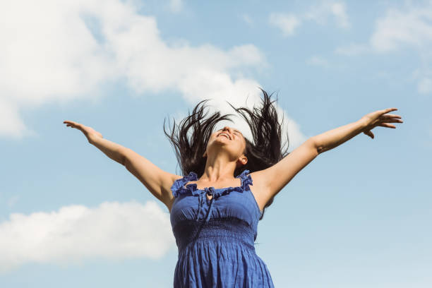 istock Pretty brunette in blue dress feeling free 824251290