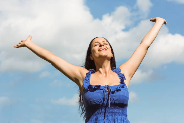 istock Smiling brunette in blue dress feeling free 824251406