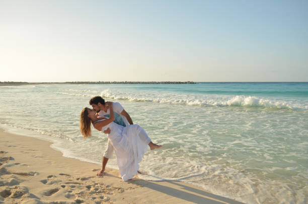 Valentine kissing on the beach Cancun, Riviera Maia, México - June 16, 2013: Valentine kissing on cancum beach, a destination world famous for romanticism and desired for honeymoons. kissing on the mouth stock pictures, royalty-free photos & images