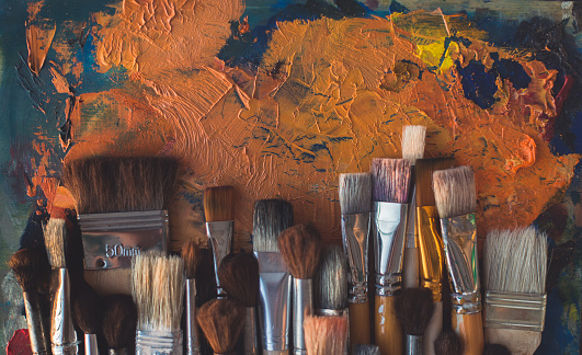 istock Top view picture of wooden paintbrush set different size with old palette on the background. 824254912