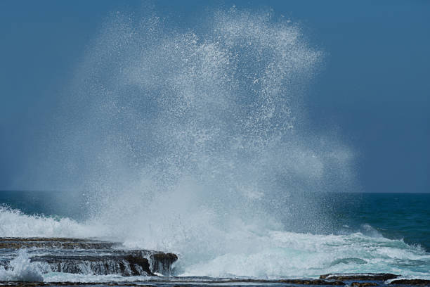 istock Energetic water splash against rock at the coast. 824262034