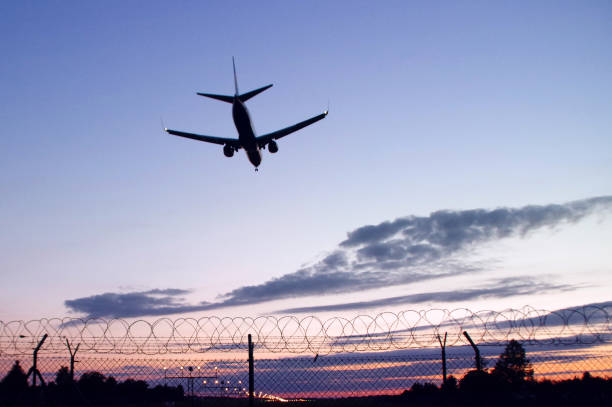istock Silhouette of aircraft landing 824263090