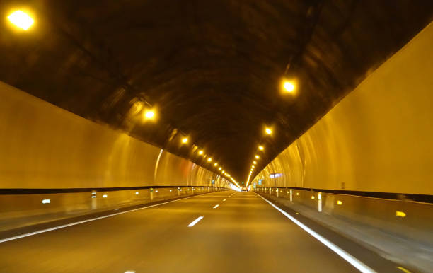 istock Driving car through a long tunnel on motorway 824270004