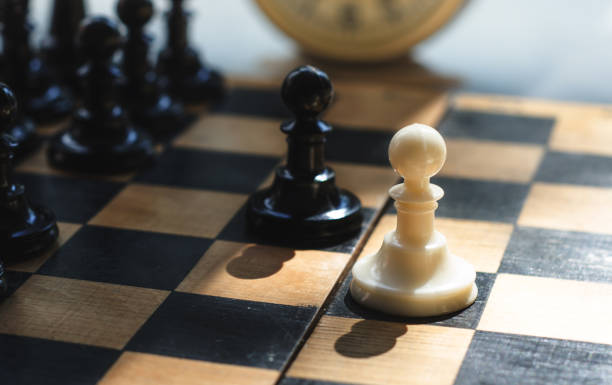 istock White and black pieces on chess board 824273136