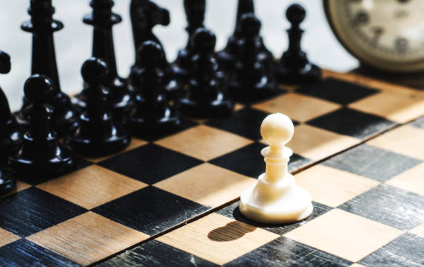 istock White and black pieces on chess board 824273188