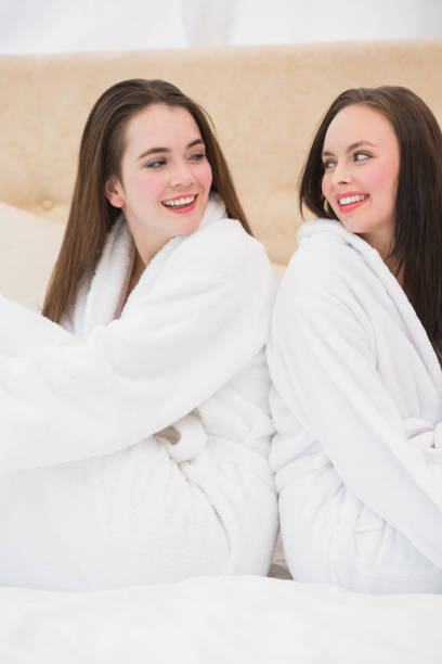 istock Pretty friends wearing white bathrobes 824273358