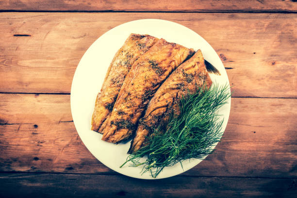 smoked mackerel fish fillet with herbs. top view