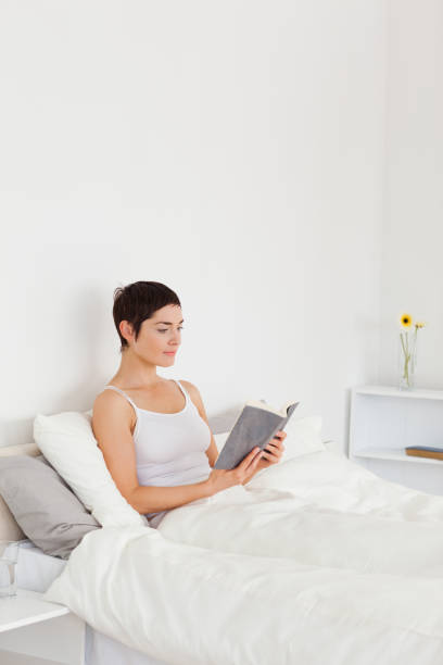 istock Portrait of a woman reading a book 824274302