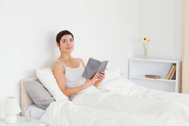 istock Young woman reading a book 824276668