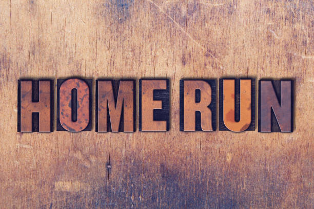 The words Home Run concept and theme written in vintage wooden letterpress type on a grunge background.