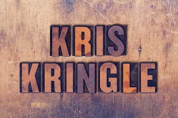 istock Kris Kringle Theme Letterpress Word on Wood Background 824277734