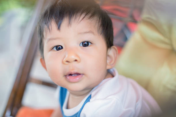 istock Cute baby in bed smiling and looking at camera. 824283720