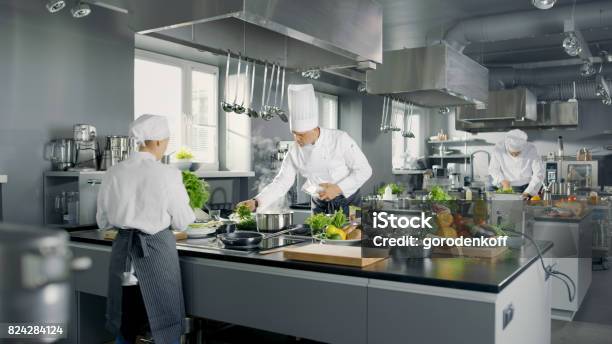 Big And Glamorous Restaurant Busy Kitchen Chefs And Cooks Working On Their Dishes Stock Photo - Download Image Now