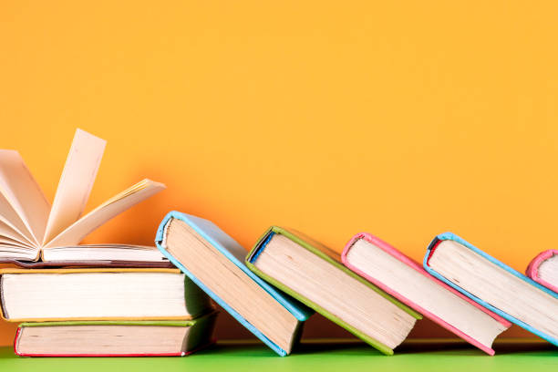 istock Open book, hardback books on bright colorful background. 824284172