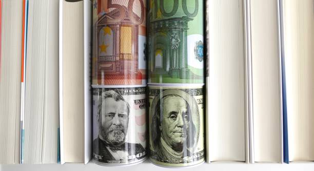 istock US dollar and euro bins standing between books 824294606