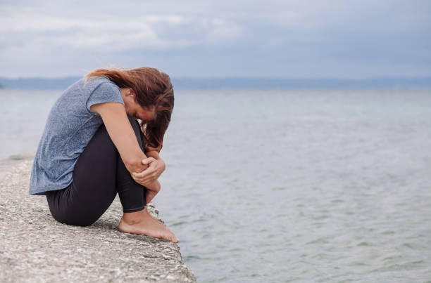 istock Woman alone and depressed on the bridge 824309792