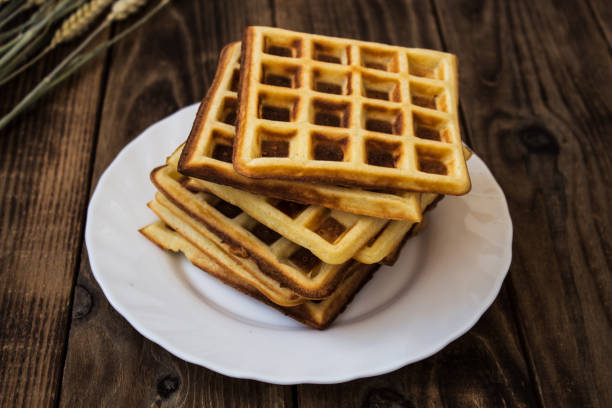 istock stack of belgian waffles on a white plate wooden background 824316334