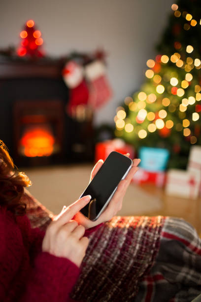 istock Woman using her mobile phone at christmas 824316748