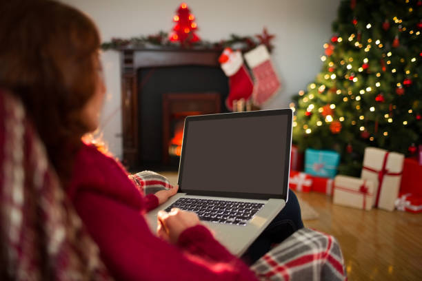 istock Rear view of redhead using laptop at christmas 824319458